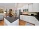 Well-lit kitchen featuring an island with granite countertops and stainless steel appliances at 6245 Hampton Golf Club Dr, Cumming, GA 30041