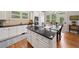 Bright kitchen with a large island, double ovens, granite countertops, and eat-in breakfast area at 6245 Hampton Golf Club Dr, Cumming, GA 30041