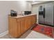 A kitchenette featuring wood cabinets, a sink, and a stainless steel refrigerator at 6245 Hampton Golf Club Dr, Cumming, GA 30041