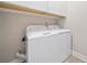 Practical laundry room featuring a modern washer and dryer, and white storage cabinets at 6245 Hampton Golf Club Dr, Cumming, GA 30041