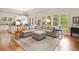 Open-concept floorplan showcasing a living room with hardwood floors and access to the kitchen at 6245 Hampton Golf Club Dr, Cumming, GA 30041