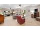 Spacious living room featuring wood-look floors, multiple windows, and a separate workout area at 6245 Hampton Golf Club Dr, Cumming, GA 30041