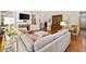Cozy living room with stone fireplace, built-in shelving, and hardwood floors at 6245 Hampton Golf Club Dr, Cumming, GA 30041