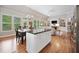 Open-concept living room featuring an island, hardwood floors, and fireplace at 6245 Hampton Golf Club Dr, Cumming, GA 30041