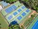 Aerial view of community tennis and pickleball courts with well-maintained greenery at 6245 Hampton Golf Club Dr, Cumming, GA 30041