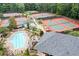 Beautiful aerial view of the pool and tennis courts in a wooded setting at 120 Bent Creek Dr, Woodstock, GA 30189