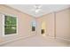 Cozy bedroom with two windows, neutral carpet, ceiling fan and floral accented wallpaper at 120 Bent Creek Dr, Woodstock, GA 30189