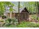 Rear exterior view of home featuring a screened in porch, lush landscaping and private setting at 120 Bent Creek Dr, Woodstock, GA 30189