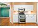 Modern kitchen with white cabinets, stainless steel microwave, and oven appliance at 120 Bent Creek Dr, Woodstock, GA 30189