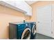 Convenient laundry room equipped with modern front loading washer and dryer and storage cabinets at 120 Bent Creek Dr, Woodstock, GA 30189