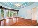 Spacious main bedroom with hardwood floors, ceiling fan, tray ceiling, and many windows at 120 Bent Creek Dr, Woodstock, GA 30189