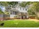Large backyard view of multi-level deck and screened in porch on a white two-story home at 2059 Howell Mill Nw Rd, Atlanta, GA 30318