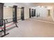 Workout area with mirrored wall and dark shelving units for storage, set on carpet at 2059 Howell Mill Nw Rd, Atlanta, GA 30318