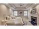 Serene bedroom featuring a fireplace, neutral decor, and a king-size bed with soft lighting at 2059 Howell Mill Nw Rd, Atlanta, GA 30318