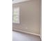 Neutral room featuring light colored carpet, an electrical outlet, and a window to the backyard at 2059 Howell Mill Nw Rd, Atlanta, GA 30318