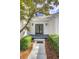 Elegant entryway featuring a striking black double door, stylish sconces, and manicured landscaping at 2059 Howell Mill Nw Rd, Atlanta, GA 30318