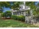 Side view of a white two-story home with a screened-in porch on a manicured lawn at 2059 Howell Mill Nw Rd, Atlanta, GA 30318
