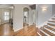 Inviting foyer with gleaming hardwood floors, staircase, and views into the dining and kitchen areas at 2059 Howell Mill Nw Rd, Atlanta, GA 30318