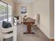 Bright office space with a desk, white chairs, and access to a screened-in porch at 2059 Howell Mill Nw Rd, Atlanta, GA 30318