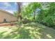 Landscaped backyard with a wooden deck and mature trees providing a serene outdoor retreat at 2702 Rollingwood Se Ln, Atlanta, GA 30316