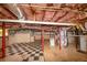 Unfinished basement with red support beams and a checkered floor offers potential for customization at 2702 Rollingwood Se Ln, Atlanta, GA 30316