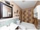 This is a bathroom with decorative tile backsplash, white toilet and white shower tub at 2702 Rollingwood Se Ln, Atlanta, GA 30316