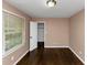 This bedroom has hard wood floors and a window with blinds at 2702 Rollingwood Se Ln, Atlanta, GA 30316