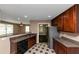 Kitchen features stainless steel appliances, wooden cabinets, tile floors and granite countertops at 2702 Rollingwood Se Ln, Atlanta, GA 30316