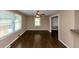 Bright living room features sleek hardwood floors, a ceiling fan, and large windows for natural light at 2702 Rollingwood Se Ln, Atlanta, GA 30316