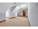 Finished attic with interesting angles, carpet flooring and neutral walls at 362 Clyde Ct, Mcdonough, GA 30252