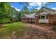 Home's backyard with green lawn, brick exterior, and back porch at 362 Clyde Ct, Mcdonough, GA 30252