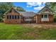 Home's backyard with green lawn and back porch at 362 Clyde Ct, Mcdonough, GA 30252