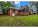 Home's backyard with green lawn and brick exterior at 362 Clyde Ct, Mcdonough, GA 30252