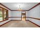 Formal dining area with carpet, decorative trim, and chandelier, open to kitchen at 362 Clyde Ct, Mcdonough, GA 30252
