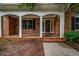 Charming brick home featuring a welcoming covered front porch with brick accents at 362 Clyde Ct, Mcdonough, GA 30252