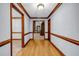 Inviting hallway with hardwood floors, wood trim, and neutral paint, seamlessly connecting rooms at 362 Clyde Ct, Mcdonough, GA 30252
