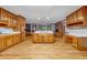 Large kitchen boasts plentiful cabinets, a center island, and wood floors at 362 Clyde Ct, Mcdonough, GA 30252