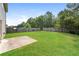Spacious backyard boasts a well-maintained lawn, privacy fence, and a concrete patio for relaxation and entertaining at 40 Oakwood Dr, Covington, GA 30016