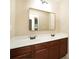 Bathroom featuring double sinks with dark wood cabinets and a large mirror offering a practical and elegant design at 40 Oakwood Dr, Covington, GA 30016