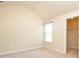 Bright bedroom features a vaulted ceiling and a window for natural light, with an attached closet at 40 Oakwood Dr, Covington, GA 30016