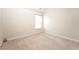 Spacious bedroom with neutral carpet, large windows, and baseboard trim at 40 Oakwood Dr, Covington, GA 30016