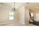 Bright dining room with an elegant chandelier and easy access to the staircase at 40 Oakwood Dr, Covington, GA 30016