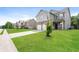 Well-manicured lawn and front view of a two-story home with a two-car garage at 40 Oakwood Dr, Covington, GA 30016