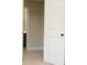 Open doorway leading to a room with neutral walls and beige carpeting creating a smooth transition at 40 Oakwood Dr, Covington, GA 30016