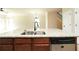 Open kitchen view featuring a large granite-topped island and stainless steel dishwasher at 40 Oakwood Dr, Covington, GA 30016