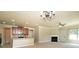 Open floor plan featuring a kitchen, fireplace, and elegant lighting fixtures at 40 Oakwood Dr, Covington, GA 30016