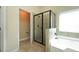Modern bathroom view of glass shower and separate bathtub with natural light at 40 Oakwood Dr, Covington, GA 30016