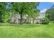 Spacious backyard with green grass and mature trees offering plenty of shade at 1907 S Van Wert Rd, Villa Rica, GA 30180