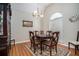 Formal dining room with hardwood floors, chandelier, and plenty of natural light from the window at 1907 S Van Wert Rd, Villa Rica, GA 30180