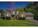 Charming two-story home features a well-manicured lawn and inviting front entrance at twilight at 1907 S Van Wert Rd, Villa Rica, GA 30180